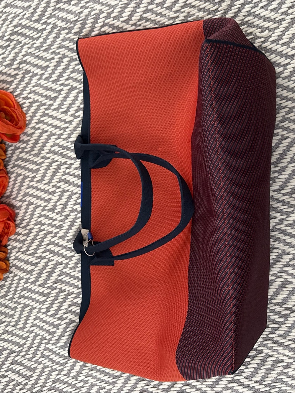 The lightweight mega tote Rothy's Orange and Burgundy Tote Bag with Navy Trim
